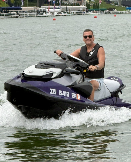 Joe Scurlock riding a personal watercraft on the lake